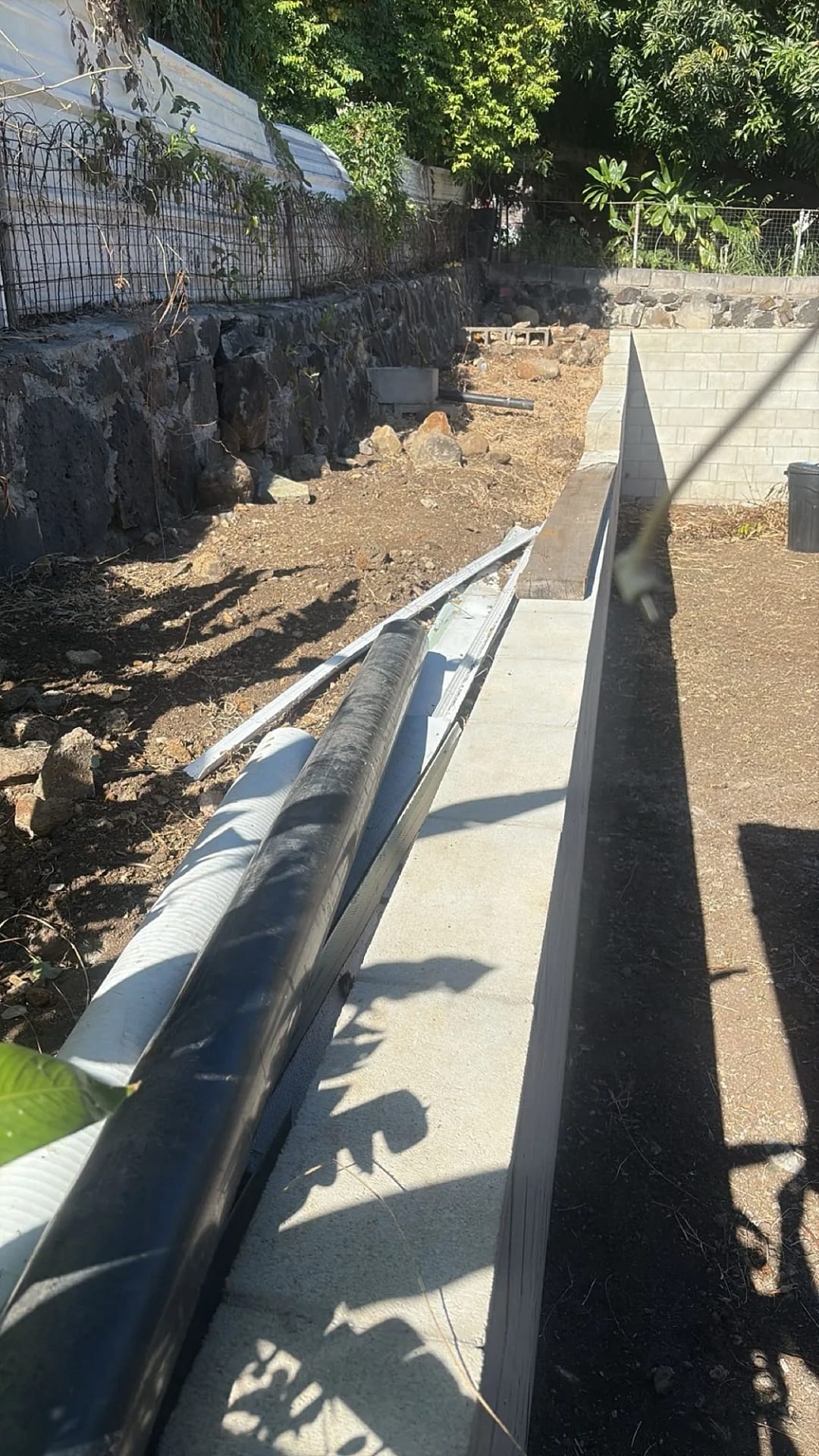 Retaining wall section with drainage pipe installed, Honolulu residence
