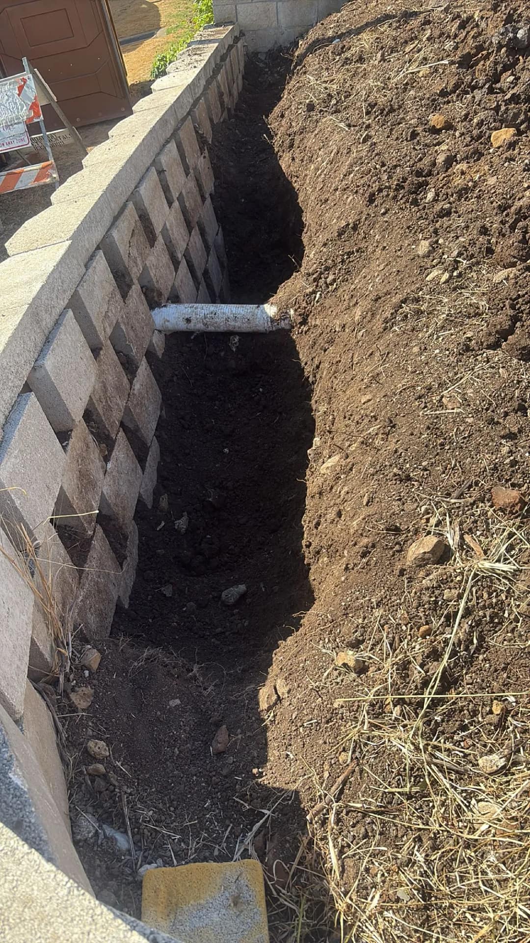 Completed retaining wall run with soil backfill, Honolulu residence