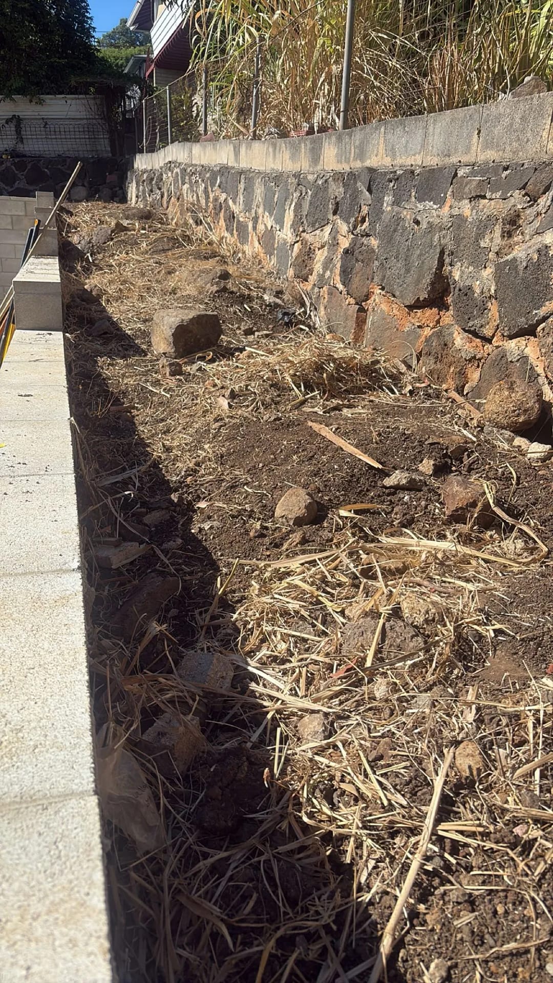 Retaining wall long run with mulch and soil fill, Honolulu residence